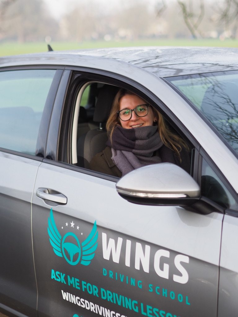 Smiling driver in a Wings Driving School car